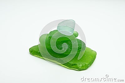 Green glass pieces found on beach. Sea glass worn smooth by the ocean. Stock Photo