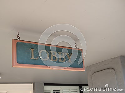 Green and gold lobby sign hanging outside at entrance of hotel Stock Photo