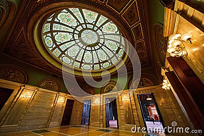 Green and gold walls in fancy entrance with Celtic stained glass on dome ceiling Editorial Stock Photo