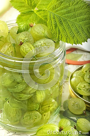 Green gooseberries in jar Stock Photo