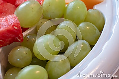Green grapes served in a plastic fruit tray Stock Photo