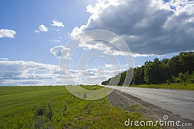 Green grass, road and blue sky Stock Photo