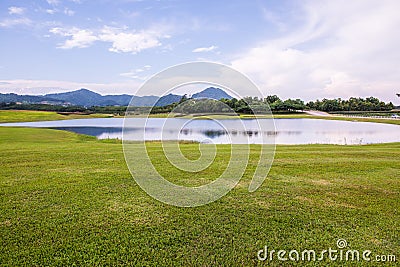 Green grass yard with lake Stock Photo