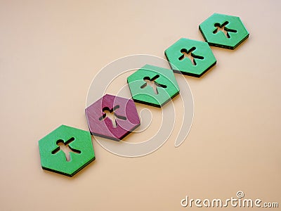 Green hexagons with figures and red one. Impostor syndrome concept. Stock Photo