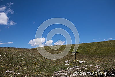 Green hills landscape with a cross Stock Photo