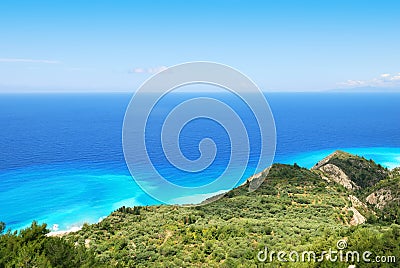 Green hillside and vast blue sea on the island of Lefkada Stock Photo