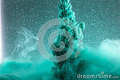 Green ink in water close-up in motion. Scientific abstract background Stock Photo