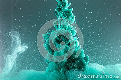 Green ink in water close-up in motion. Scientific abstract background Stock Photo
