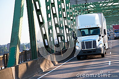 Green interstate bridge with commertial freight semi trucks on h Stock Photo