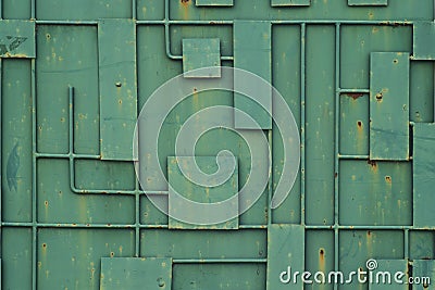 Green iron fence with a pattern of geometric lines of metal. Stock Photo