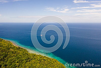 Green island with coral reef. Coast of Camiguin Island, Philippines, view from above Stock Photo