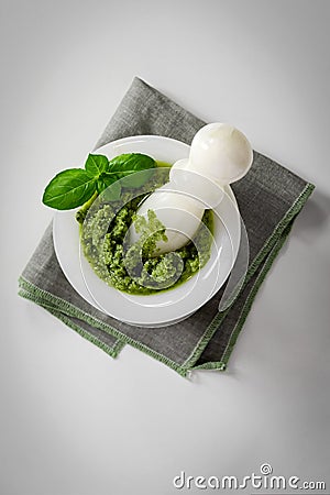 Green italian homemade sauce pesto in stone pounder Stock Photo
