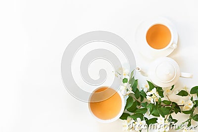 Green jasmin tea and jasmine flowers, cup of green tea on white background. Top view. Copy space. Stock Photo
