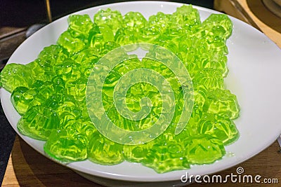 Green Jello isolated on a white plate. Green Jelly, green gelatine Stock Photo