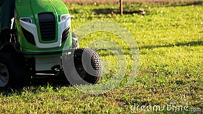 Green lawn mower tractor. Editorial Stock Photo