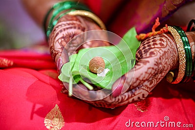 Green leaf and supari in bride hand Stock Photo