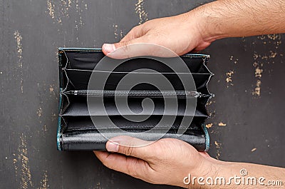 Green leather wallet with no money on black wooden background Stock Photo