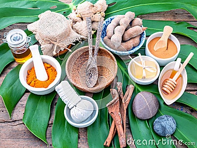Green leaves with nature spa ingredient turmeric powder in white Stock Photo