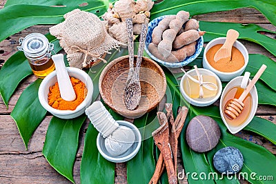 Green leaves with nature spa ingredient turmeric powder in white Stock Photo