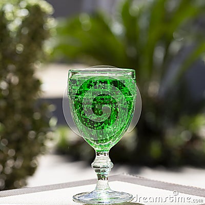 close-up Green lemonade Tarragon in a glass glass on a blurry background. Green drink from healthy herbs Tarragon Stock Photo