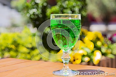 close-up Green lemonade Tarragon in a glass glass on a blurry background. Green drink from healthy herbs Tarragon Stock Photo