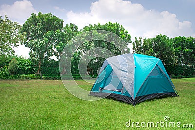 Green light dome tent without rain fly setup on campsite. Stock Photo