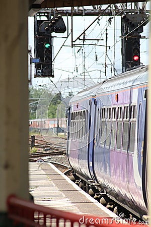 Green light for train leaving railway station Editorial Stock Photo