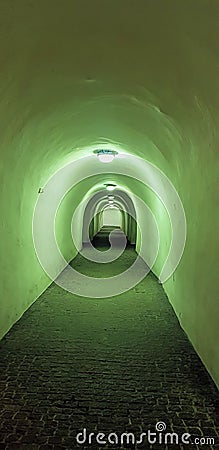 Green Light Underground Arched Tunnel Stock Photo