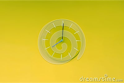 Green lime round modern analog glass clocks hang on a light yellow green wall. Shows the current time eight pm Stock Photo
