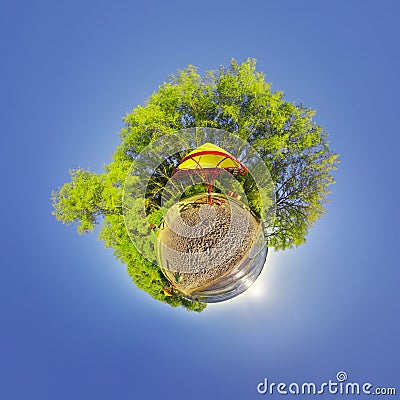 Green little planet with trees and soft blue sky. Tiny planet sunset at the beach. 360 viewing angle. Planet Earth. Stock Photo