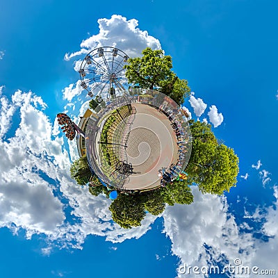 Green little planet with trees, white cluds and soft blue sky. Tiny planet of amusement park. 360 viewing angel. Editorial Stock Photo