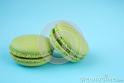 Green macarons on blue background Stock Photo