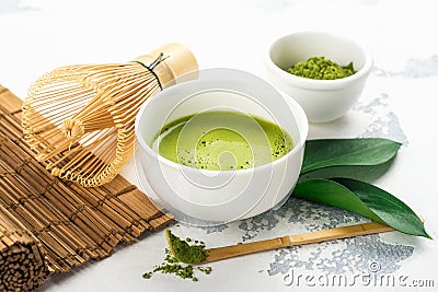 Green matcha tea drink and tea accessories on white background Stock Photo