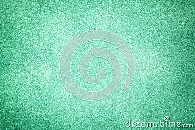 Green matte background of suede fabric with vignette. Texture of velvet textile Stock Photo