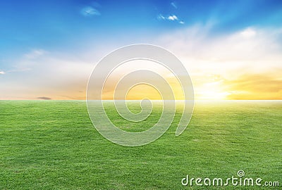 Green meadow and with sunset and blue sky. Stock Photo