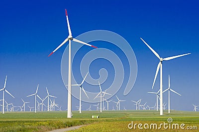 Green meadow with wind turbines Stock Photo