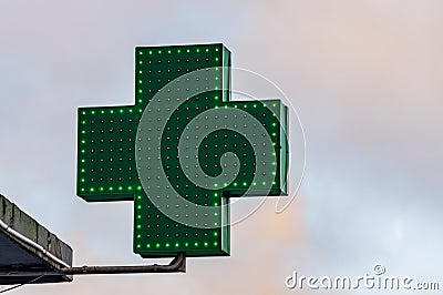 Green medical cross sign in winter day Stock Photo