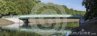 green metal bridge at a lake in Cologne, Decksteiner Weiher Stock Photo