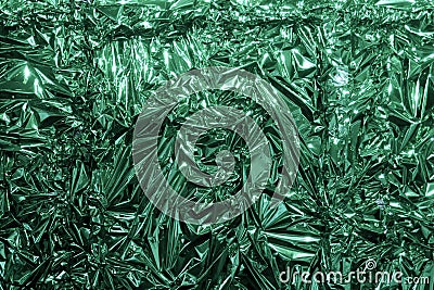 Green metal foil, wrinkled and shiny. Close-up, abstract image background Stock Photo