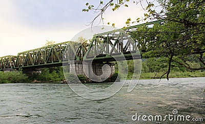 Green metal railway bridge across the Sava river Stock Photo