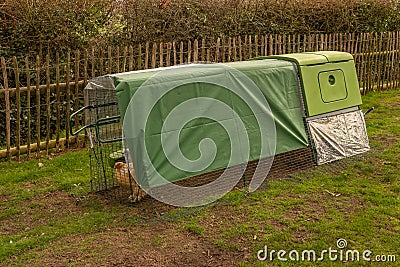 A green modern bright looking chicken coup or hen house with covered top Stock Photo