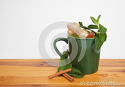 Green mug filled with natural herbal ingredients Stock Photo