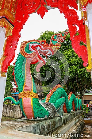 Green Naga in front of the temple gate Stock Photo