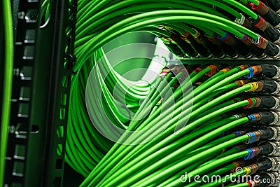Green network wires connected to the server Stock Photo