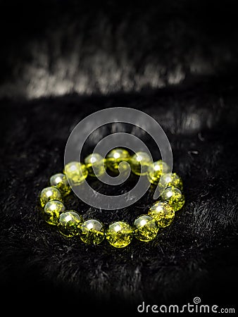 Green Olivine or Green Peridote lucky stone bracelet Beads with black haircloth Stock Photo