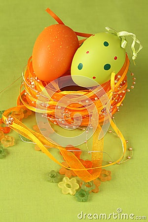 Green and orange Easter egg in a nest Stock Photo