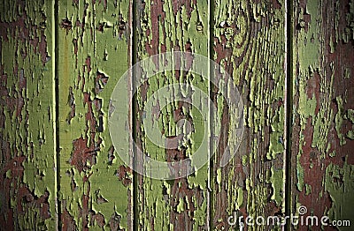 Green paint peeling from a wooden panel door Stock Photo