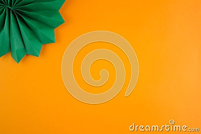 Dark green decorative paper cigar on an orange textured background Stock Photo