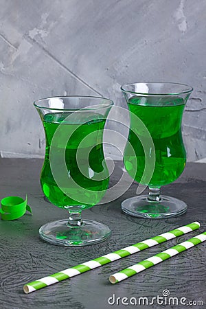 Green party beverages in irish glasses and straws Stock Photo