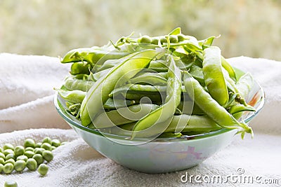 Green peas. Hulk pods in a glass bowl Stock Photo